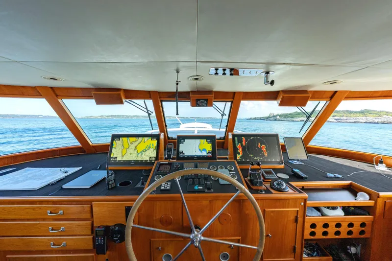 Slide: The Image of Helm of a 1966 Burger Classic yacht with navigation equipment and ocean view. - 40