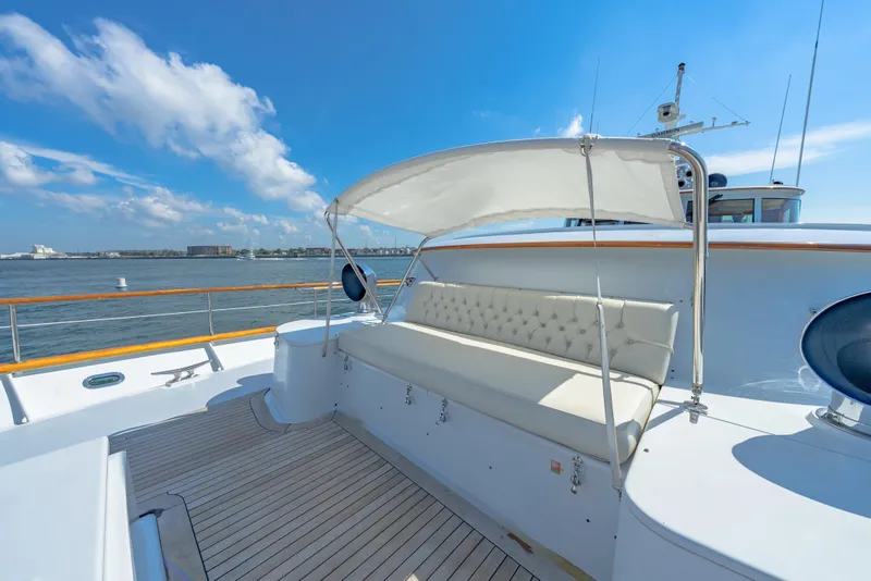 Slide: The Image of Classic 1966 Burger yacht deck with cushioned seating and canopy, overlooking serene waters. - 42