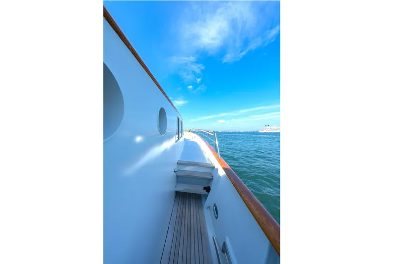 Slide: The Image of Side view of a 1966 Burger Classic yacht on a sunny day at sea. - 45