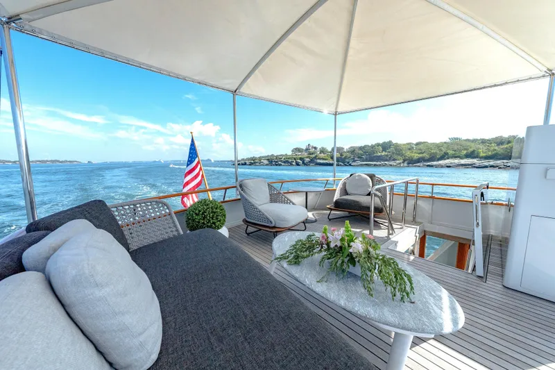 Slide: The Image of Luxurious 1966 Burger Classic yacht deck with seating, ocean view, and American flag. - 47