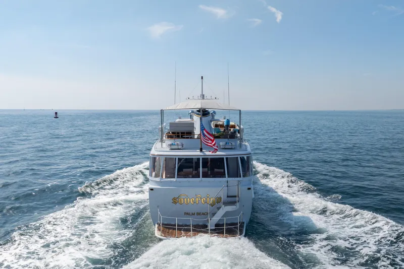 Slide: The Image of Classic 1966 Burger yacht "Sovereign" cruising on open sea with American flag. - 56