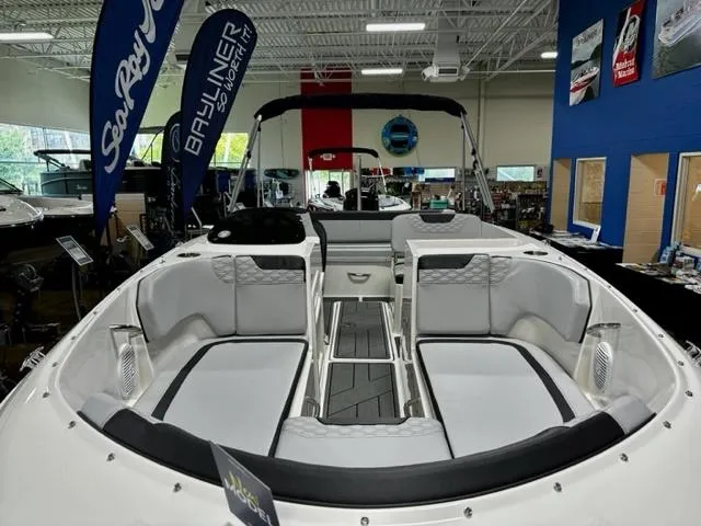 Slide: The Image of 2023 Bayliner Element M19 boat interior at a showroom. - 2