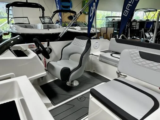Slide: The Image of 2023 Bayliner Element M19 boat interior with seating and steering wheel. - 3