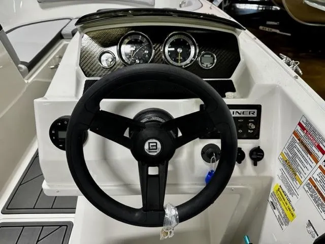 Slide: The Image of 2023 Bayliner Element M19 boat dashboard with steering wheel and instrument panel. - 5