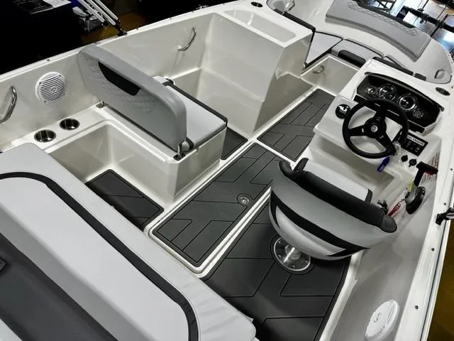 Slide: The Image of 2023 Bayliner Element M19 boat interior with seating and steering console. - 6