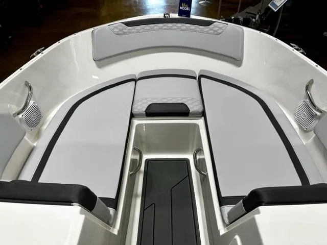 Slide: The Image of 2023 Bayliner Element M19 boat interior with cushioned seating and storage compartments. - 7