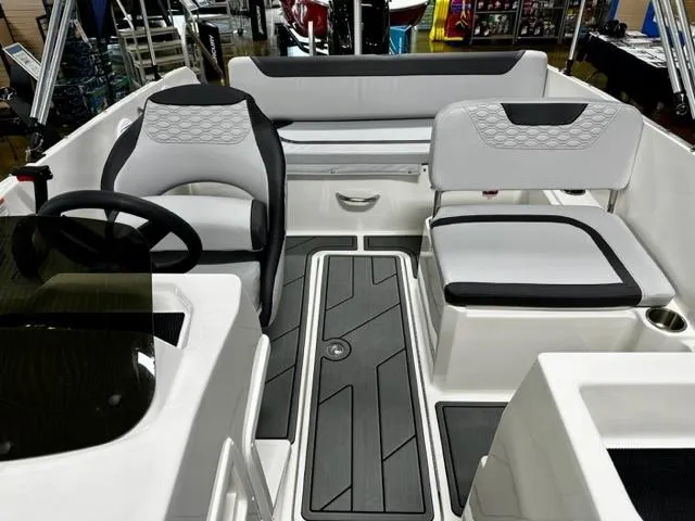 Slide: The Image of 2023 Bayliner Element M19 boat interior with modern seating and steering wheel. - 8