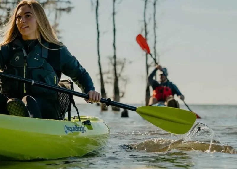 Slide: The Image of Two people kayaking on a lake with Liquidlogic Kiawah 12 kayaks, 2023 model. - 3