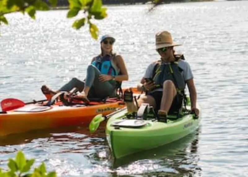 Slide: The Image of Two people kayaking on Liquidlogic Manta Ray Propel 12 kayaks, 2023 model. - 2