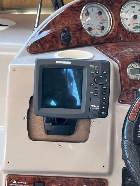 Slide: The Image of 2005 Rinker Fiesta Vee 320 dashboard with Humminbird fish finder and gauges. - 18