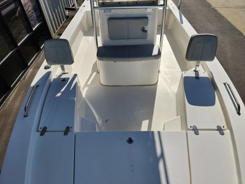 Slide: The Image of 2023 May-Craft 220 Bay boat interior with seating and storage compartments. - 14