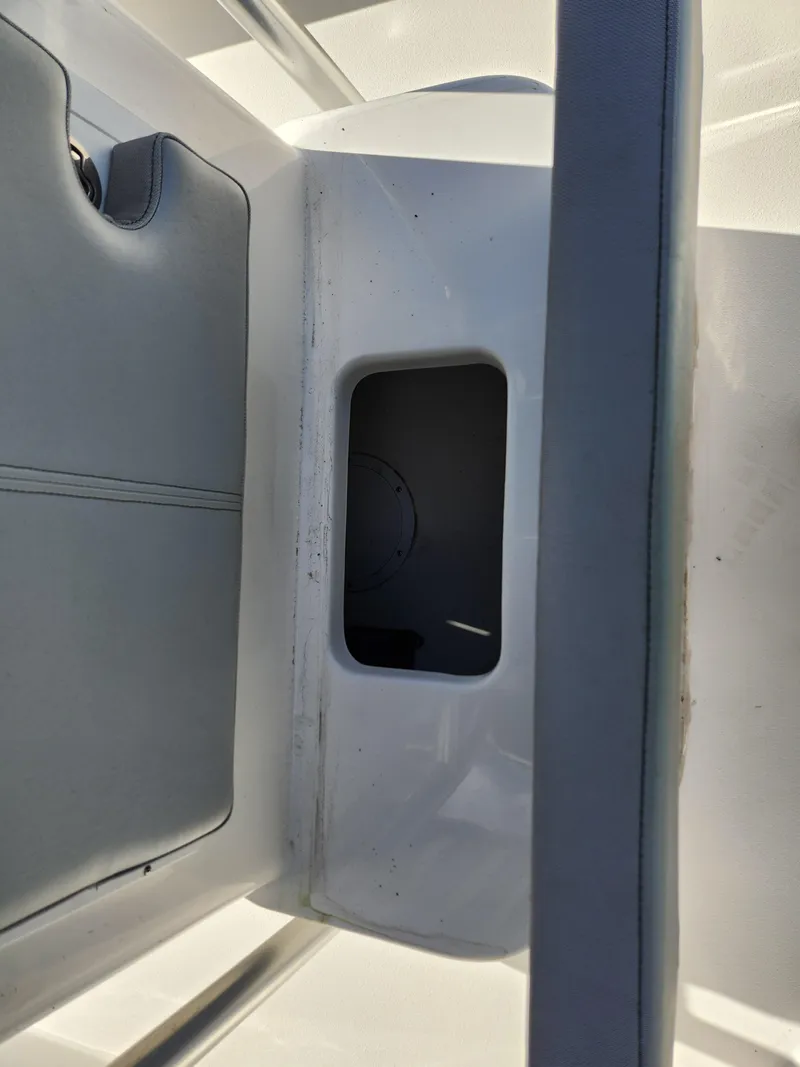 Slide: The Image of 2023 May-Craft 220 Bay boat interior detail with storage compartment. - 16