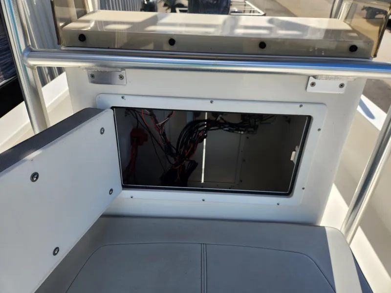 Slide: The Image of 2023 May-Craft 220 Bay boat interior wiring compartment with open access panel. - 17