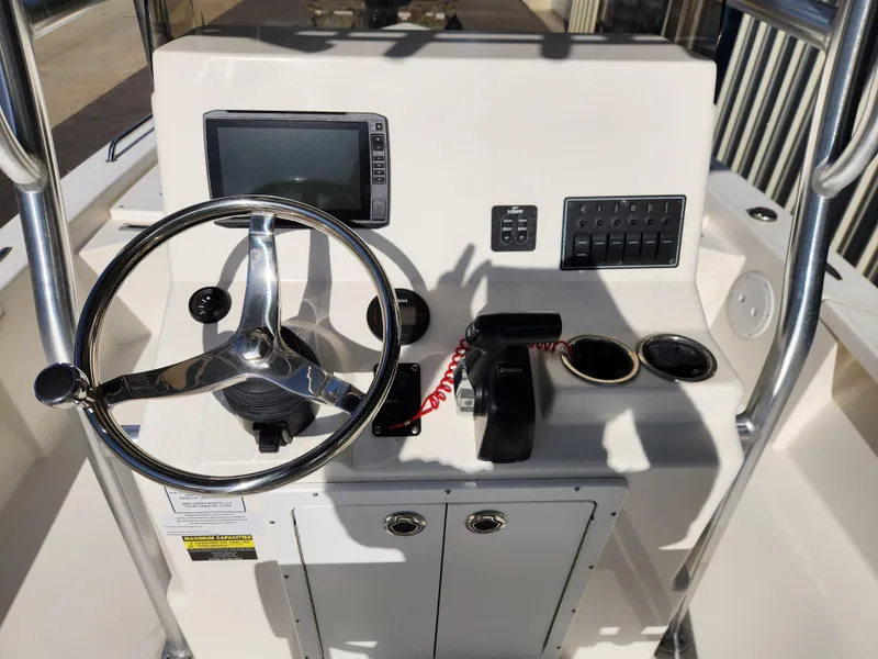 Slide: The Image of 2023 May-Craft 220 Bay boat console with steering wheel and navigation controls. - 19