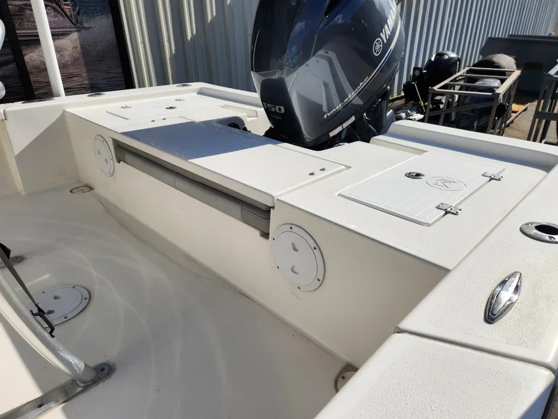 Slide: The Image of 2023 May-Craft 220 Bay boat with Yamaha outboard motor, white deck, and storage compartments. - 24