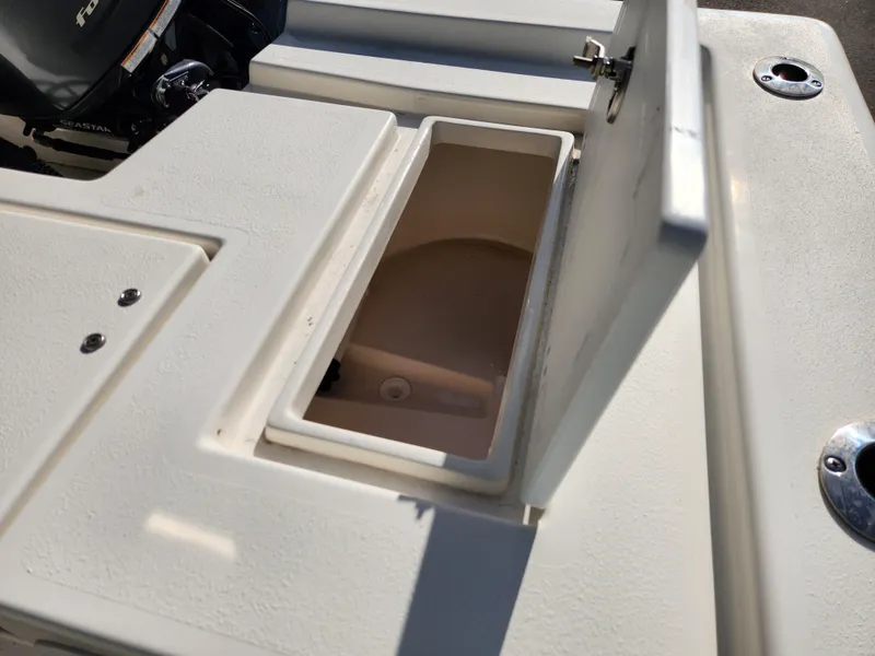 Slide: The Image of 2023 May-Craft 220 Bay boat storage compartment open, showcasing interior space. - 26