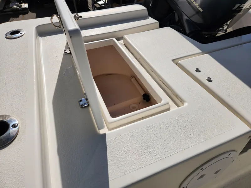 Slide: The Image of 2023 May-Craft 220 Bay boat with open storage compartment. - 27