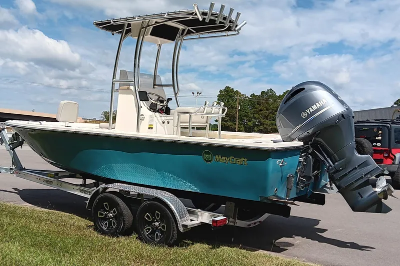 Slide: The Image of 2023 May-Craft 220 Bay boat with Yamaha outboard engine on a trailer, parked outdoors. - 4