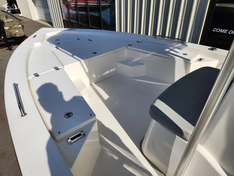 Slide: The Image of 2023 May-Craft 220 Bay boat interior with seating and storage compartments. - 7