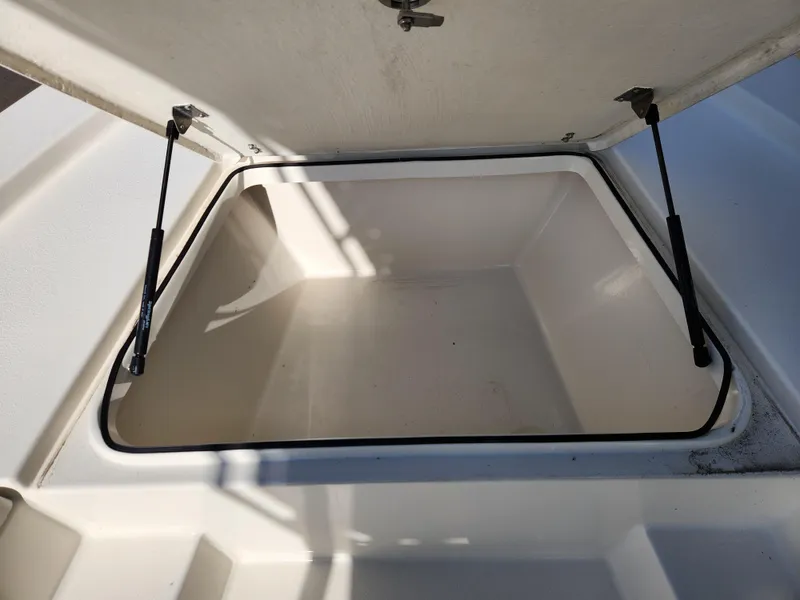 Slide: The Image of Open storage compartment on 2023 May-Craft 220 Bay boat. - 9