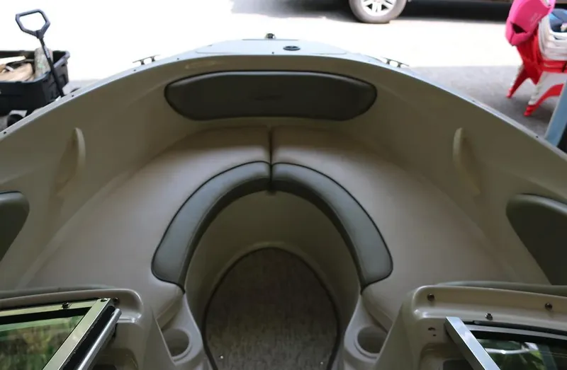 Slide: The Image of 2005 Sea Ray 200 Sport boat interior with cushioned seating. - 10