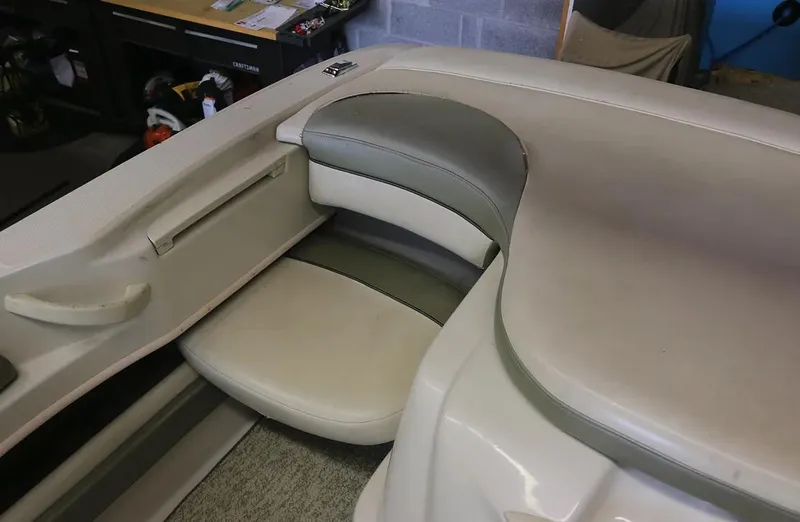 Slide: The Image of 2005 Sea Ray 200 Sport boat interior seating area with storage compartment. - 12