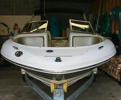 Slide: The Image of 2005 Sea Ray 200 Sport boat in a garage on a trailer. - 3