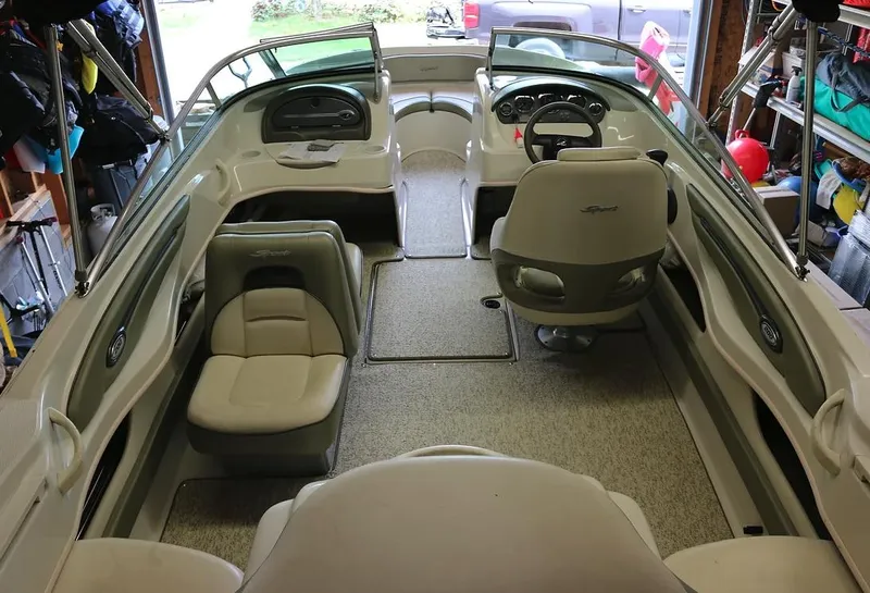 Slide: The Image of 2005 Sea Ray 200 Sport boat interior with seating and steering wheel. - 5