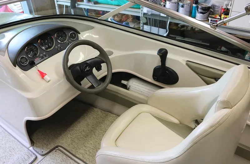 Slide: The Image of Interior cockpit of a 2005 Sea Ray 200 Sport boat with steering wheel and controls. - 6