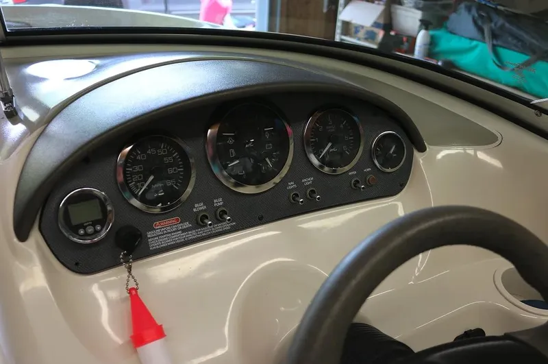 Slide: The Image of 2005 Sea Ray 200 Sport dashboard with gauges and controls. - 7