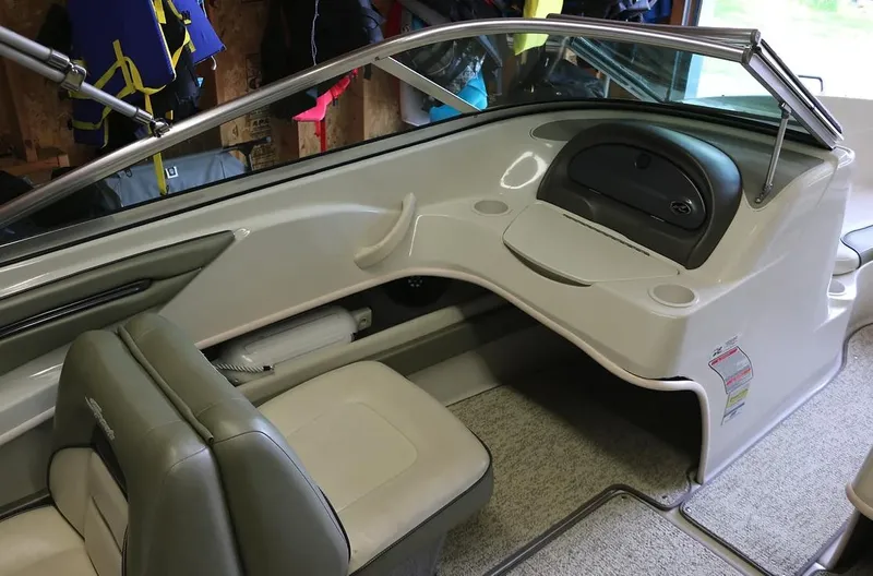 Slide: The Image of Interior of a 2005 Sea Ray 200 Sport boat with seating and dashboard. - 8