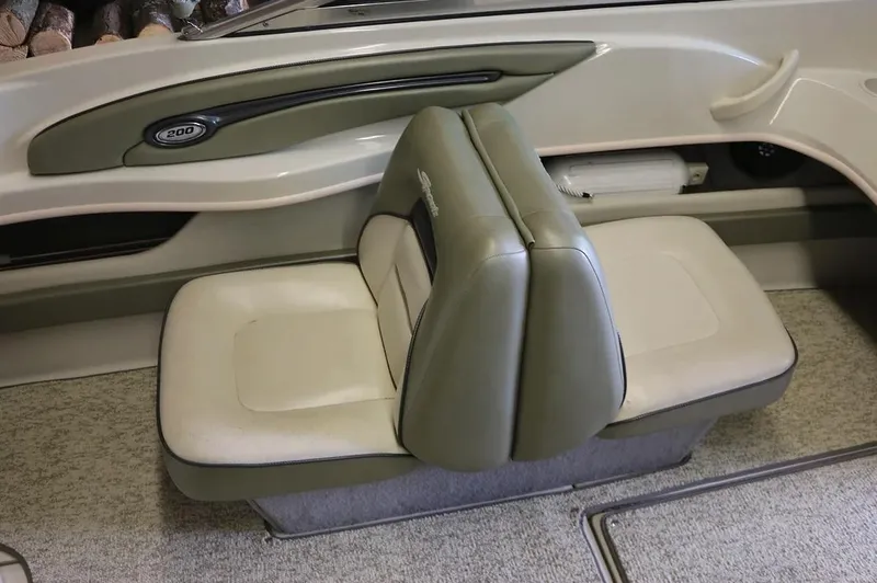Slide: The Image of 2005 Sea Ray 200 Sport boat interior seating with green and white upholstery. - 9