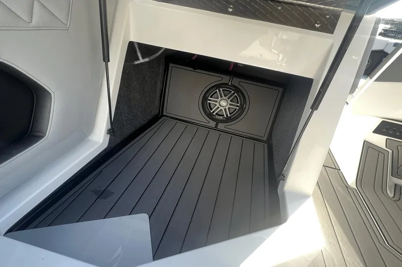 Slide: The Image of 2024 Nautique Super Air Nautique GS24 interior with speaker and sleek flooring. - 10