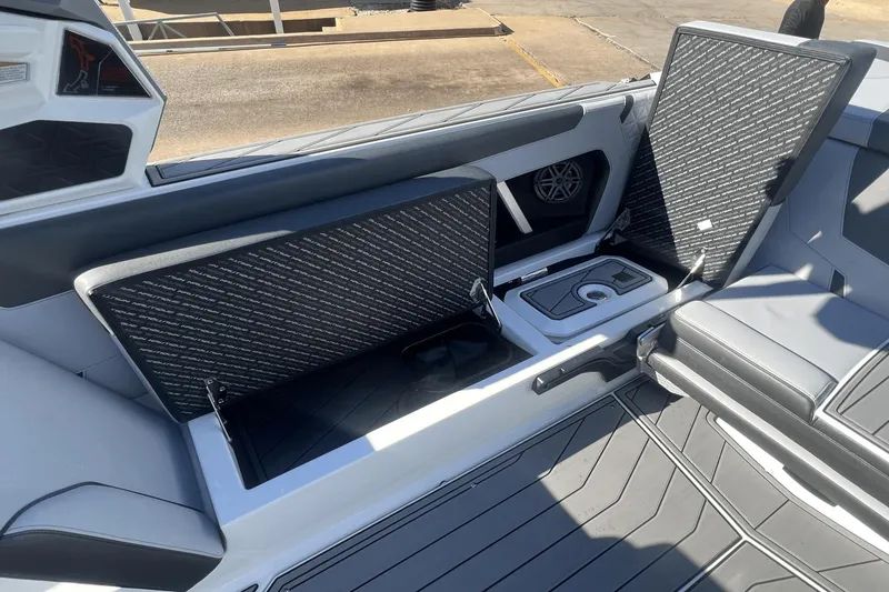Slide: The Image of 2024 Nautique Super Air Nautique GS24 interior storage compartments and seating area. - 11