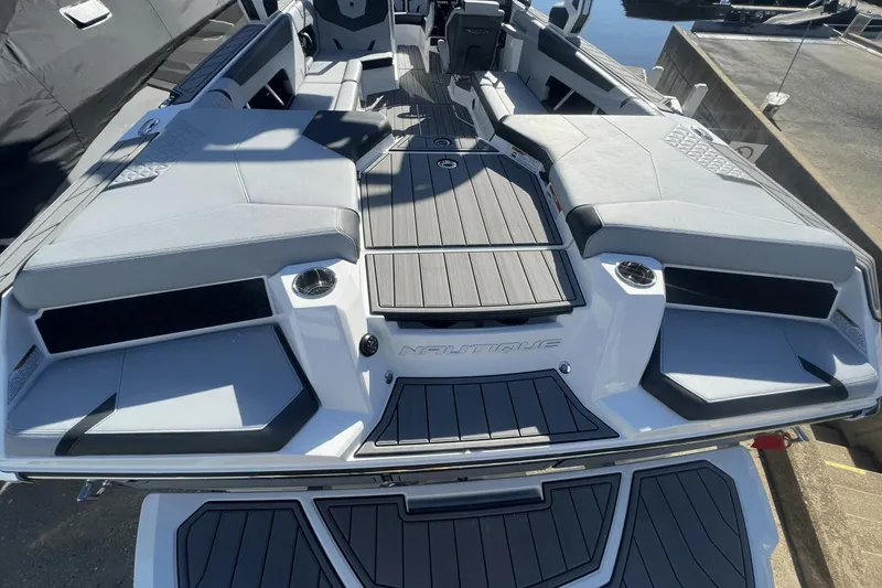 Slide: The Image of 2024 Nautique Super Air Nautique GS24 boat interior with sleek seating and modern design. - 12