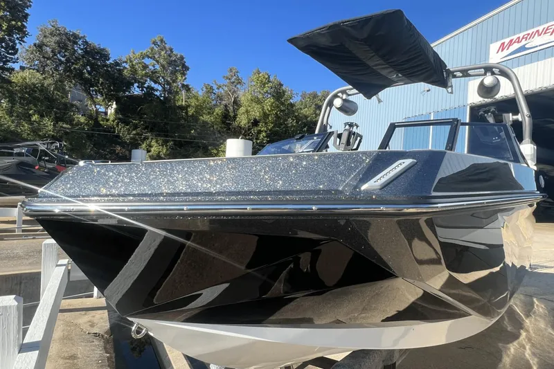 Slide: The Image of 2024 Nautique Super Air Nautique GS24 boat with sleek design and glittering finish. - 14
