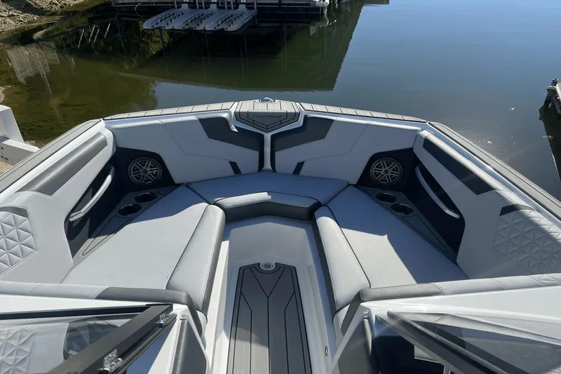Slide: The Image of 2024 Nautique Super Air Nautique GS24 boat interior with luxurious seating and cup holders. - 6