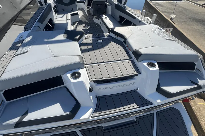 Slide: The Image of 2024 Nautique Super Air Nautique GS24 boat interior with sleek seating and modern design. - 7