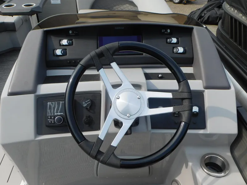 Slide: The Image of 2023 Bennington 23LFB boat steering console with modern controls and sleek design. - 7