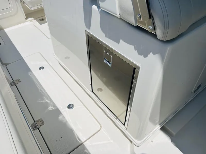 Slide: The Image of 2024 Sailfish 360 CC boat interior with storage compartments and seating. - 11