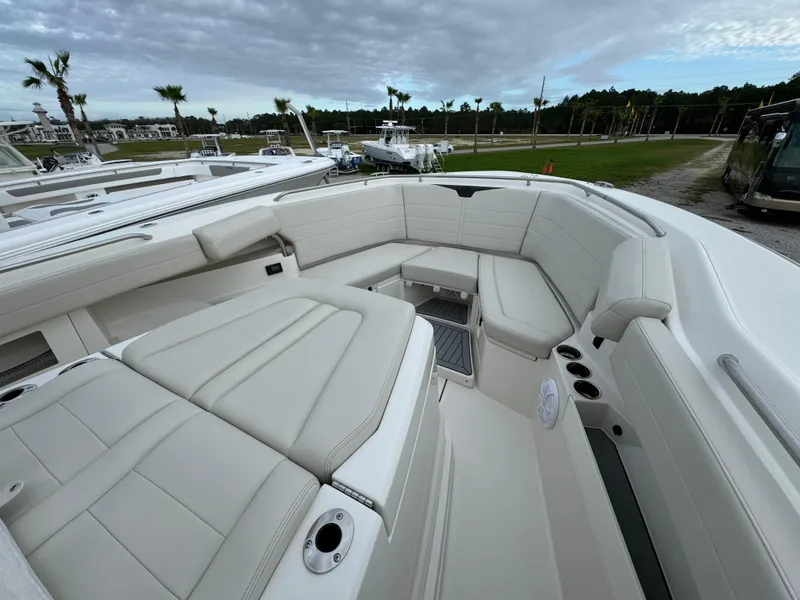 Slide: The Image of 2024 Sailfish 360 CC boat interior with spacious seating and cup holders. - 12