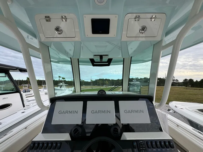 Slide: The Image of 2024 Sailfish 360 CC boat cockpit with Garmin navigation displays. - 16