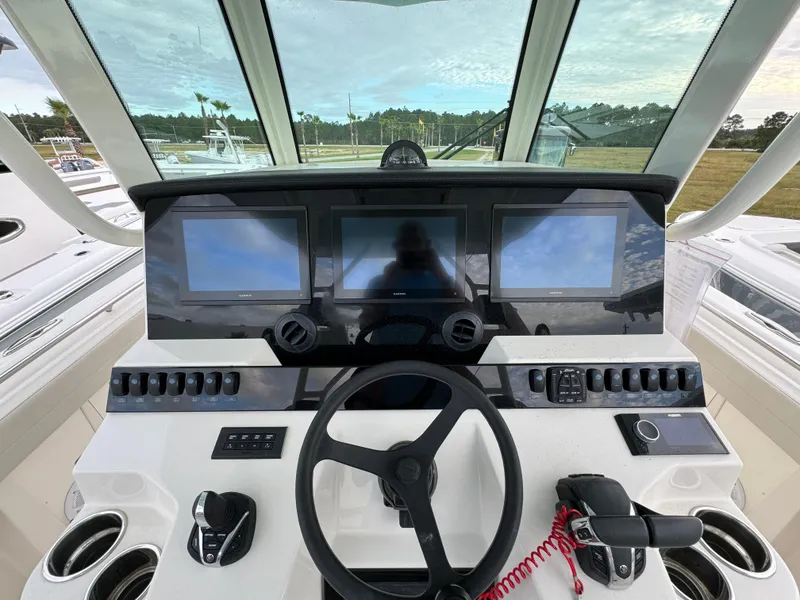Slide: The Image of 2024 Sailfish 360 CC helm with advanced navigation displays and controls. - 17
