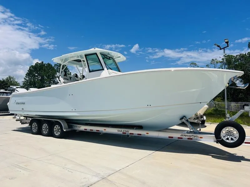 Slide: The Image of 2024 Sailfish 360 CC boat on trailer under clear blue sky. - 2