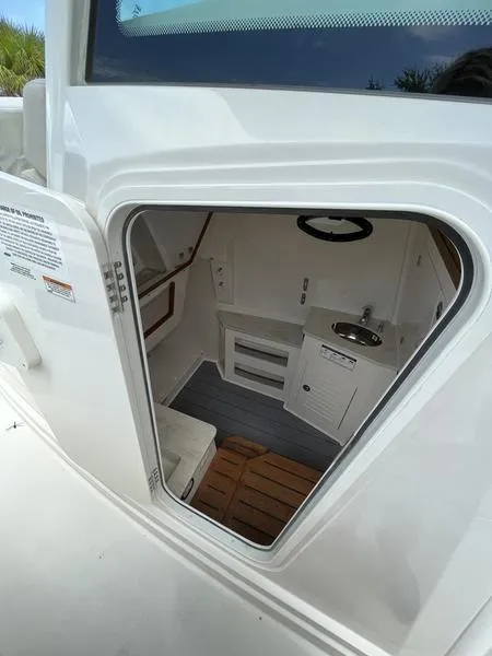 Slide: The Image of 2024 Sailfish 360 CC cabin interior with sink and storage compartments. - 28