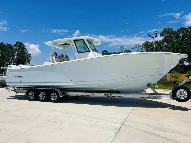 Slide: The Image of 2024 Sailfish 360 CC boat on trailer under clear blue sky. - 3