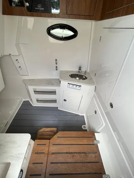Slide: The Image of Interior cabin of 2024 Sailfish 360 CC boat with sink and wooden flooring. - 32
