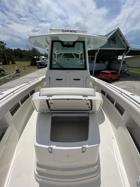 Slide: The Image of 2024 Sailfish 360 CC boat with Garmin electronics, open storage compartment, and seating area. - 36