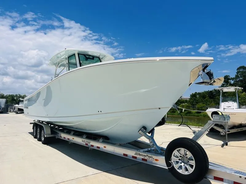 Slide: The Image of 2024 Sailfish 360 CC boat on trailer under clear blue sky. - 4