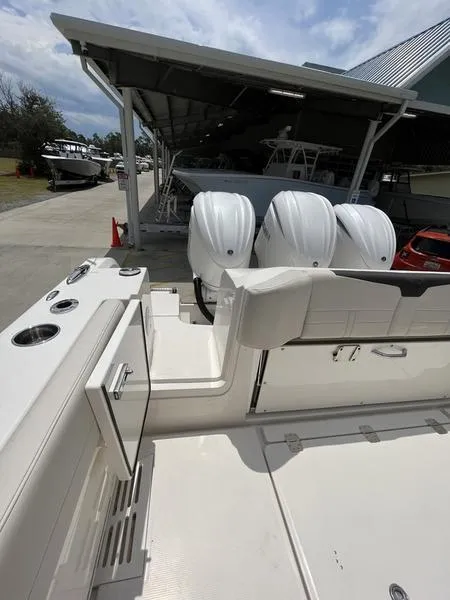 Slide: The Image of 2024 Sailfish 360 CC boat with triple outboard engines in a marina. - 41